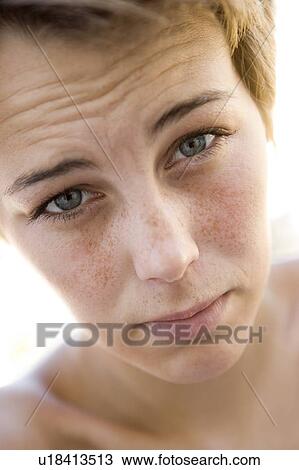 Stock Image - Head shot of sad woman. Fotosearch