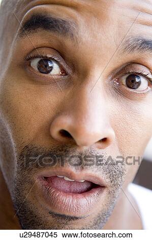 Stock Photography - Head shot of surprised man. Fotosearch