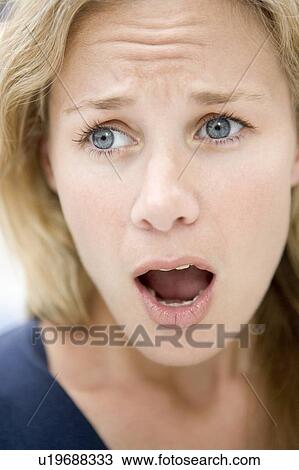 Stock Image - Head shot of surprised woman. Fotosearch