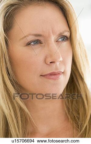 Picture - Head shot of woman scowling. Fotosearch