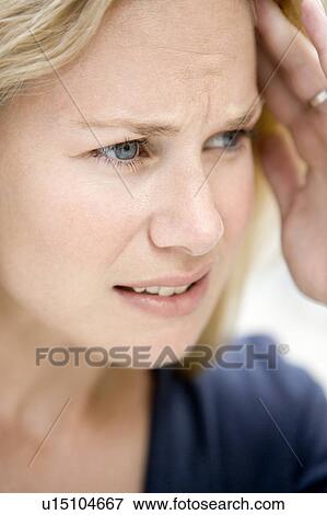 Stock Photo - Head shot of woman scowling. Fotosearch