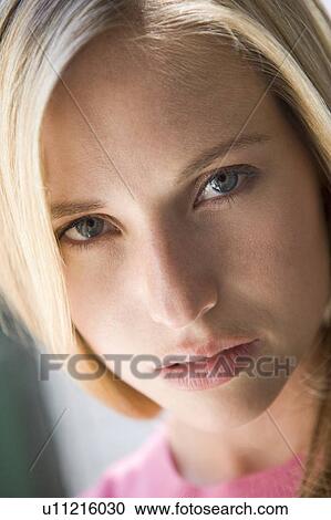 Stock Image - Head shot of woman thinking. Fotosearch