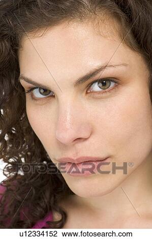 Stock Image - Head shot of woman thinking. Fotosearch