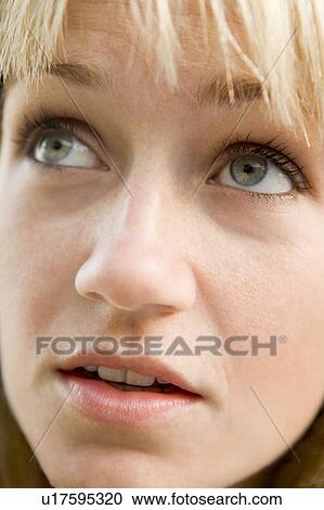Stock Image - Head shot of woman thinking. Fotosearch