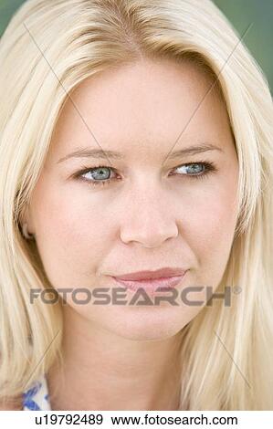Stock Photo - Head shot of woman thinking. Fotosearch