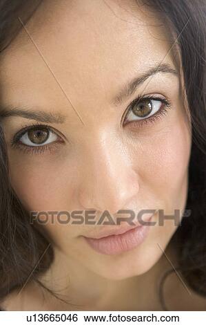 Stock Photograph - Head shot of woman thinking. Fotosearch