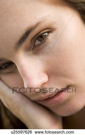 Stock Photograph - Head shot of woman thinking. Fotosearch