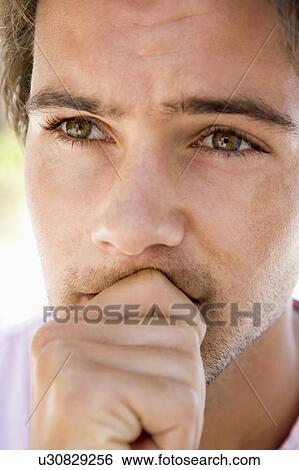 Stock Photograph - Head shot of worried man. Fotosearch