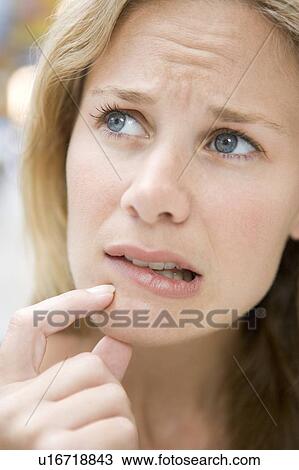 Stock Image - Head shot of worried woman. Fotosearch