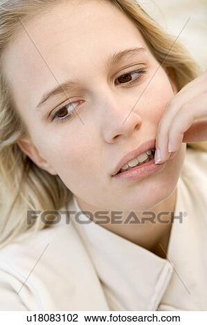 Stock Image - Head shot of worried woman. Fotosearch