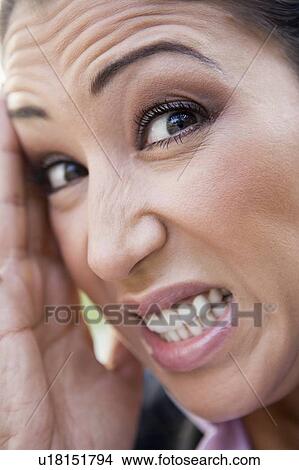 Picture - Woman's frustrated face outdoors (selective focus). Fotosearch