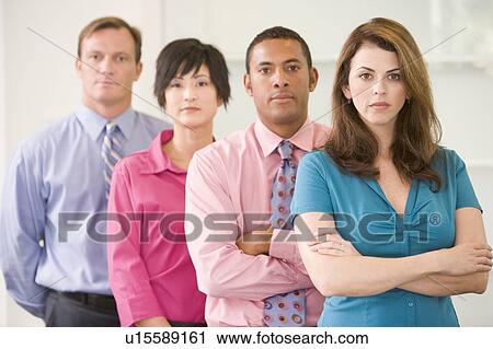Business team standing indoors View Large Photo Image Stock Image - Business team standing indoors. Fotosearch
