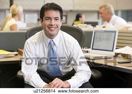 Businessman in cubicle smiling View Large Photo Image Picture - Businessman in cubicle smiling. Fotosearch