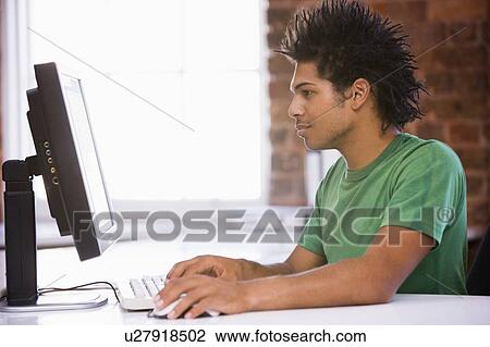 Businessman in office typing on computer View Large Photo Image Stock Image - Businessman in office typing on computer. Fotosearch