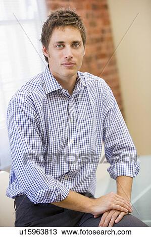 Businessman sitting in office View Large Photo Image Stock Image - Businessman sitting in office. Fotosearch