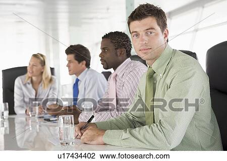 Four businesspeople in a boardroom View Large Photo Image Stock Image - Four businesspeople in a boardroom. Fotosearch