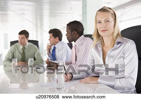 Stock Photo - Four businesspeople in a boardroom. Fotosearch