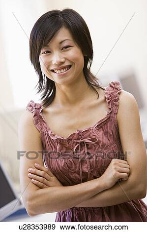 Woman standing in computer room smiling View Large Photo Image Stock Photo - Woman standing in computer room smiling. Fotosearch