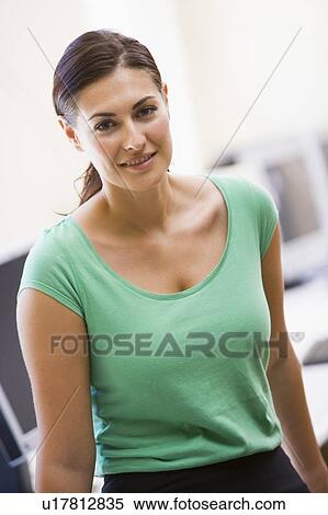 Woman standing in computer room smiling View Large Photo Image Stock Photography - Woman standing in computer room smiling. Fotosearch