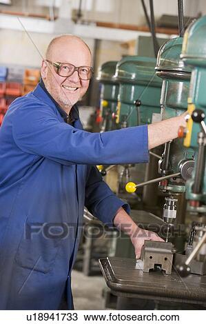 Machinist working on machine View Large Photo Image Stock Image - Machinist working on machine. Fotosearch