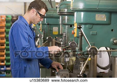 Machinist working on machine View Large Photo Image Stock Photo - Machinist working on machine. Fotosearch