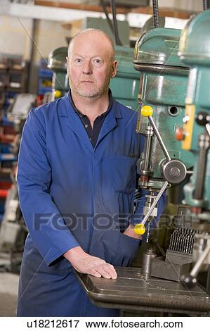 Machinist working on machine View Large Photo Image Stock Photo - Machinist working on machine. Fotosearch