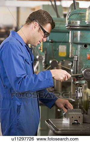 Machinist working on machine View Large Photo Image Stock Photograph - Machinist working on machine. Fotosearch
