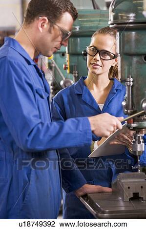 Two machinists working on machine View Large Photo Image Stock Image - Two machinists working on machine. Fotosearch