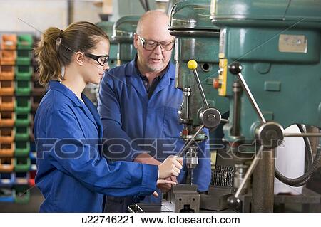 Two machinists working on machine View Large Photo Image Stock Image - Two machinists working on machine. Fotosearch
