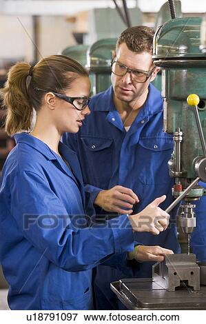 Stock Photo - Two machinists working on machine. Fotosearch