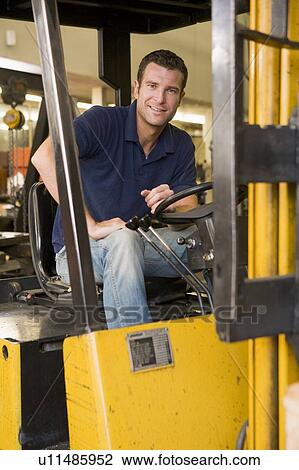 Warehouse worker in forklift View Large Photo Image Stock Image - Warehouse worker in forklift. Fotosearch
