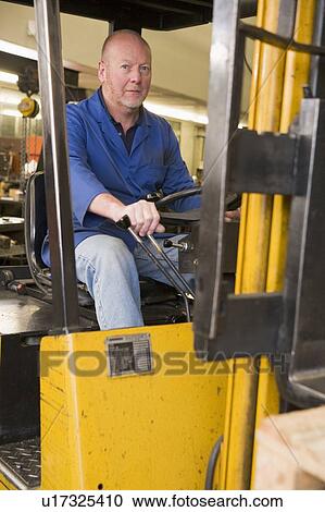 Warehouse worker in forklift View Large Photo Image Stock Image - Warehouse worker in forklift. Fotosearch