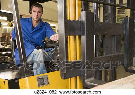 Warehouse worker in forklift View Large Photo Image Stock Image - Warehouse worker in forklift. Fotosearch