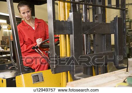Warehouse worker in forklift View Large Photo Image Stock Photo - Warehouse worker in forklift. Fotosearch