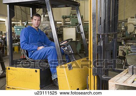 Stock Photography - Warehouse worker in forklift. Fotosearch