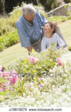 Grandfather and grandson working in the garden. View Large Photo Image Stock Photo - Grandfather and grandson working in the garden.. Fotosearch
