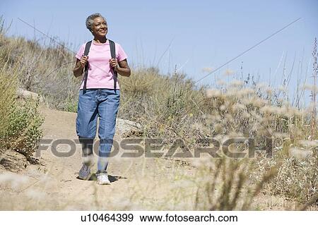 Senior woman on a walking trail View Large Photo Image Stock Photo - Senior woman on a walking trail. Fotosearch