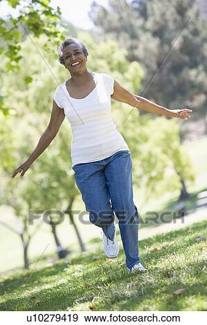 Senior woman walking in park View Large Photo Image Stock Photo - Senior woman walking in park. Fotosearch