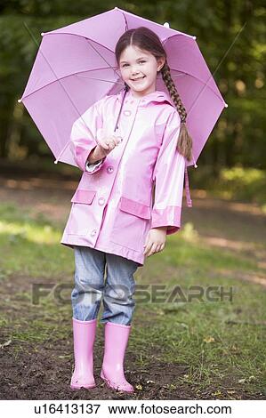 Young girl outdoors with umbrella smiling View Large Photo Image Stock Photo - Young girl outdoors with umbrella smiling. Fotosearch