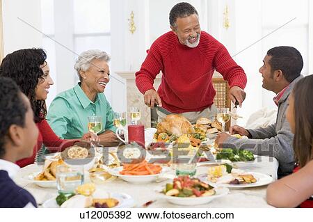 Stock Image - Family All Together At Christmas Dinner. Fotosearch