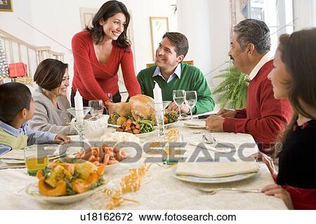 Stock Image - Family All Together At Christmas Dinner. Fotosearch
