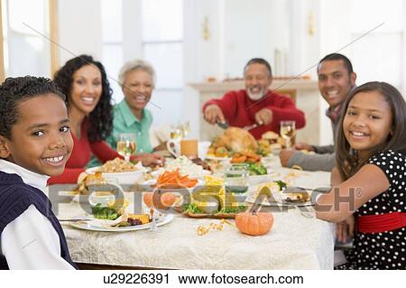 Stock Image - Family All Together At Christmas Dinner. Fotosearch