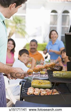 Family Enjoying A Barbeque View Large Photo Image Stock Image - Family Enjoying A Barbeque. Fotosearch