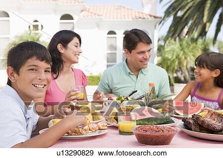 Stock Photo - Family Enjoying A Barbeque. Fotosearch
