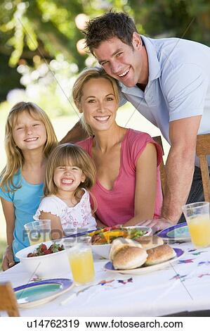 Stock Photo - Family Enjoying A Barbeque. Fotosearch