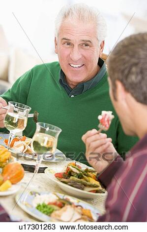 Father And Son At Christmas Dinner View Large Photo Image Stock Image - Father And Son At Christmas Dinner. Fotosearch