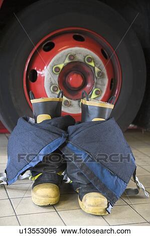 Firefighting uniform on floor by fire engine View Large Photo Image Stock Photograph - Firefighting uniform on floor by fire engine. Fotosearch