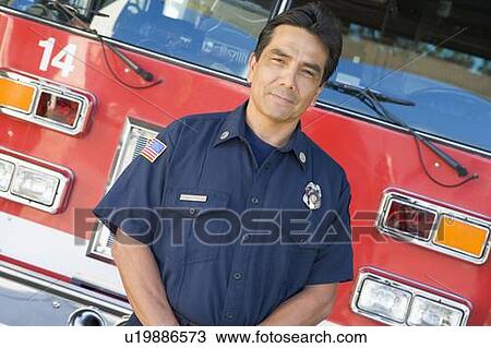 Fireman standing in front of fire engine View Large Photo Image Stock Image - Fireman standing in front of fire engine. Fotosearch