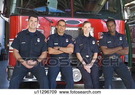 Four firefighters leaning on fire engine View Large Photo Image Stock Photo - Four firefighters leaning on fire engine. Fotosearch