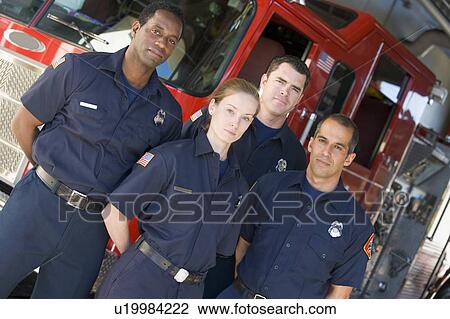 Four firefighters standing in front of fire engine View Large Photo Image Stock Image - Four firefighters standing in front of fire engine. Fotosearch